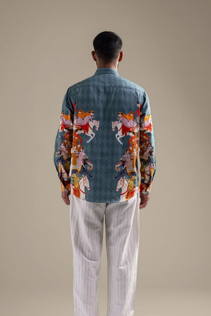 Man wearing the blue Kirtharjuna shirt, back view