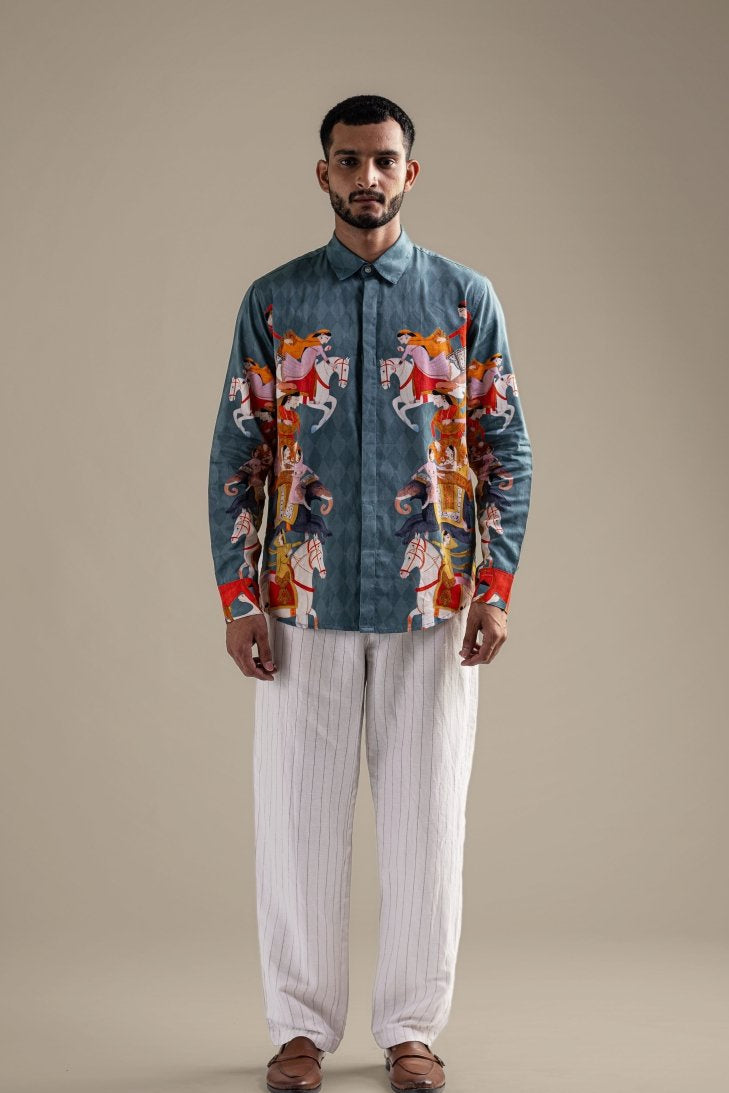 Man wearing the blue Kirtharjuna shirt, front view, arms at his sides