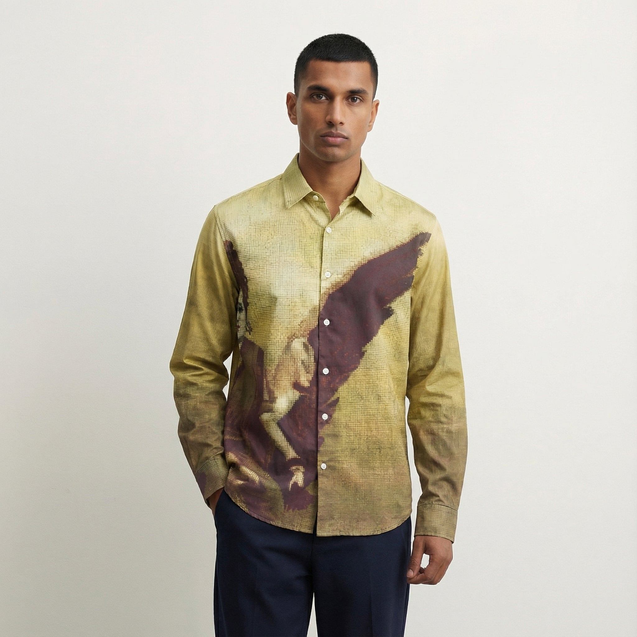 Man wearing a patterned shirt with a neutral background
