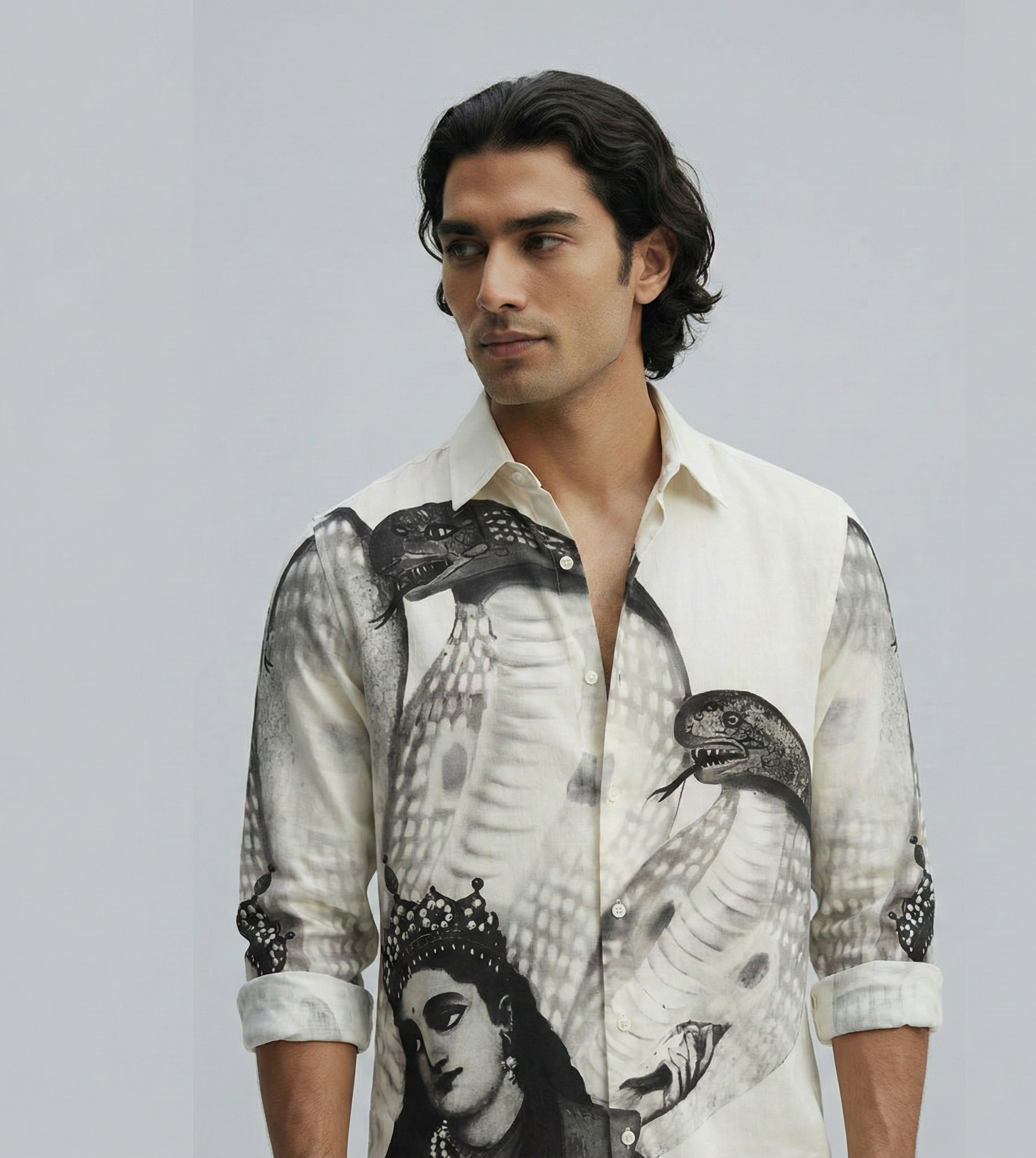 Man wearing a shirt with a graphic design on a gray background