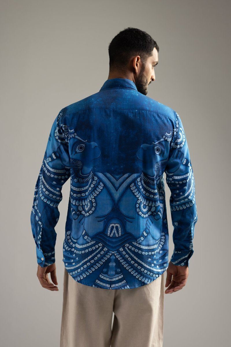 Man wearing the Vanaryugalam shirt, three-quarter back view, looking over his shoulder