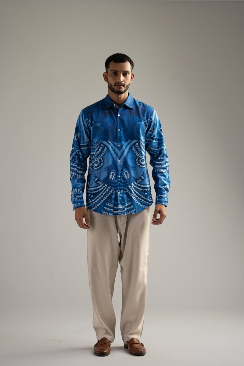 Man wearing the Vanaryugalam shirt for men in indigo blue Giza cotton with cream trousers, full length front view